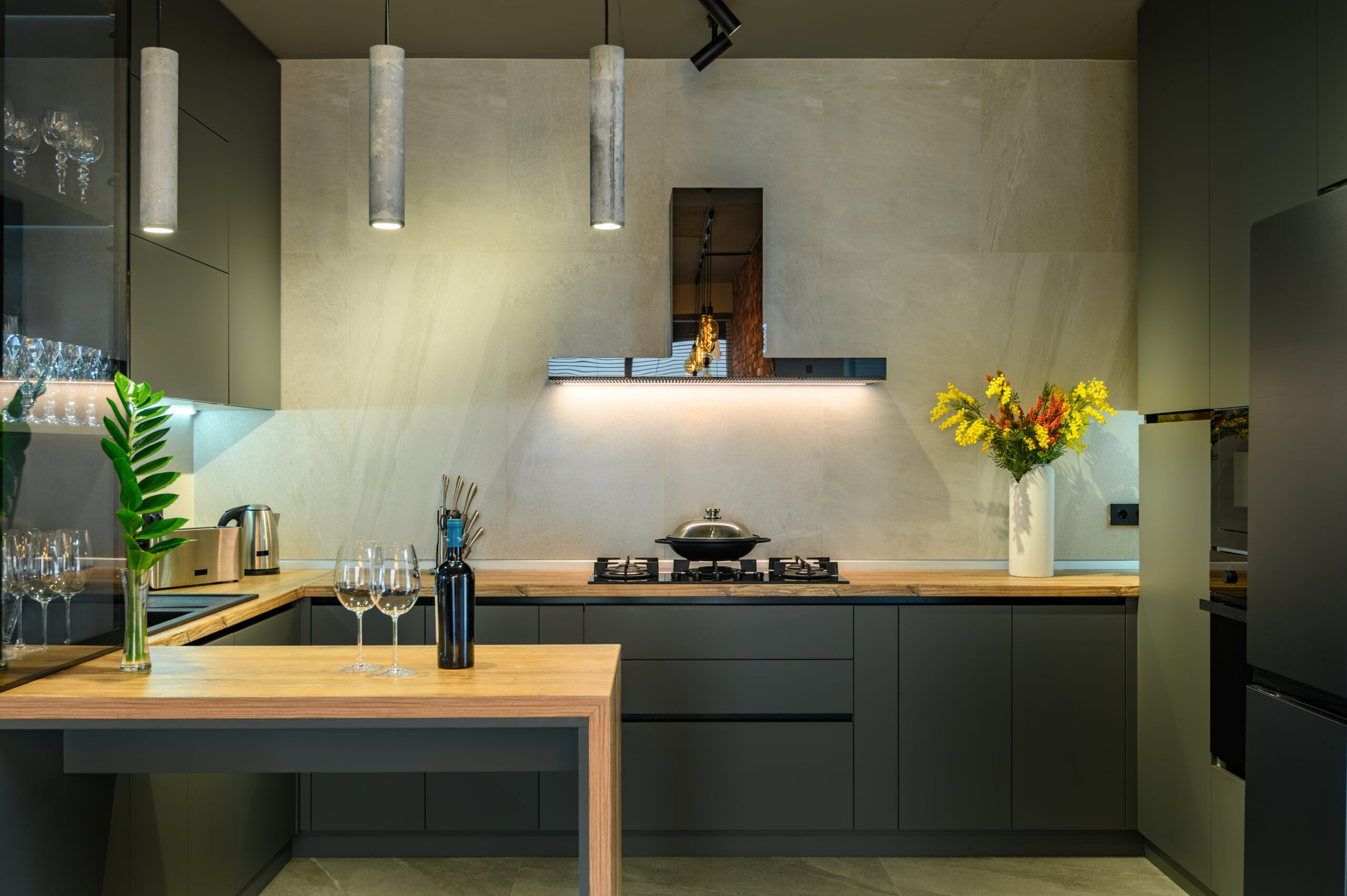 Modern luxury loft studio apartment interior with dark grey kitchen