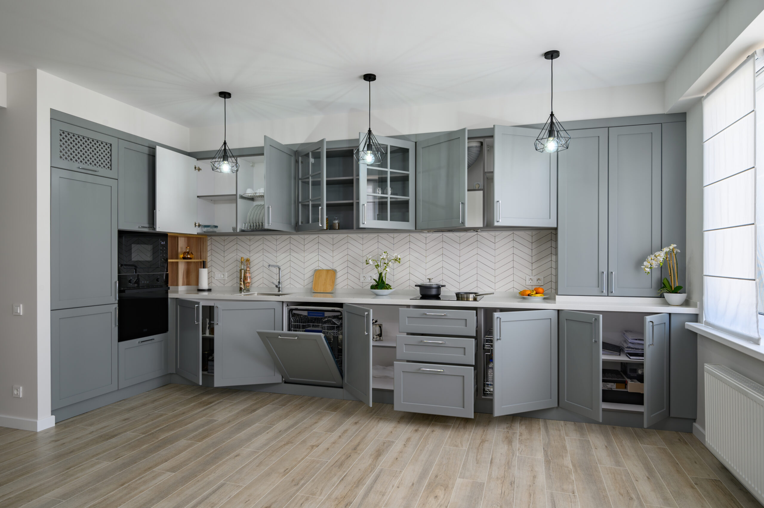 Trendy grey and white modern kitchen furniture showcase with most of doors open