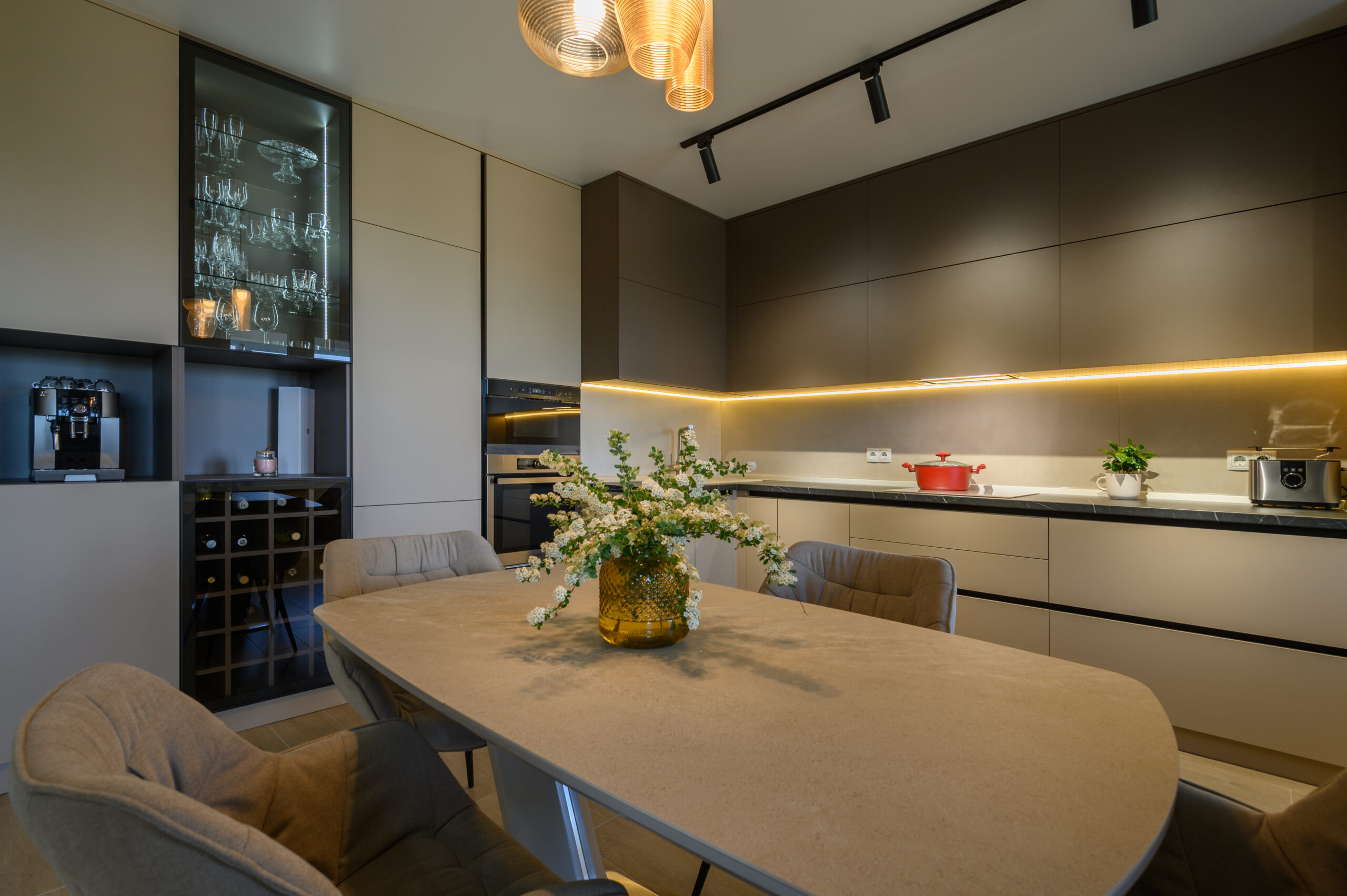 Large modern grey luxurious kitchen and dining room in studio apartment interior