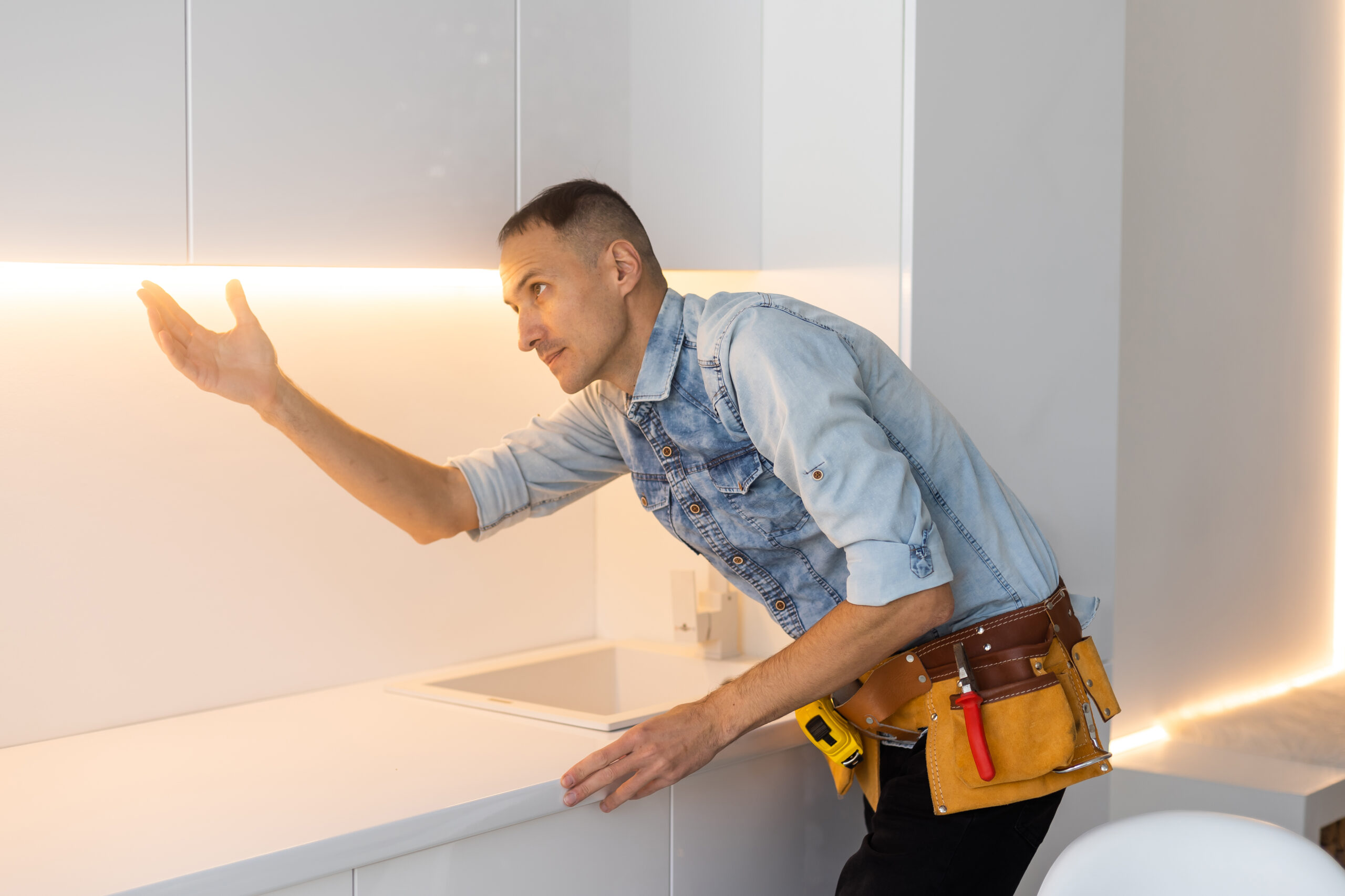 Young man working with kitchen equipment.