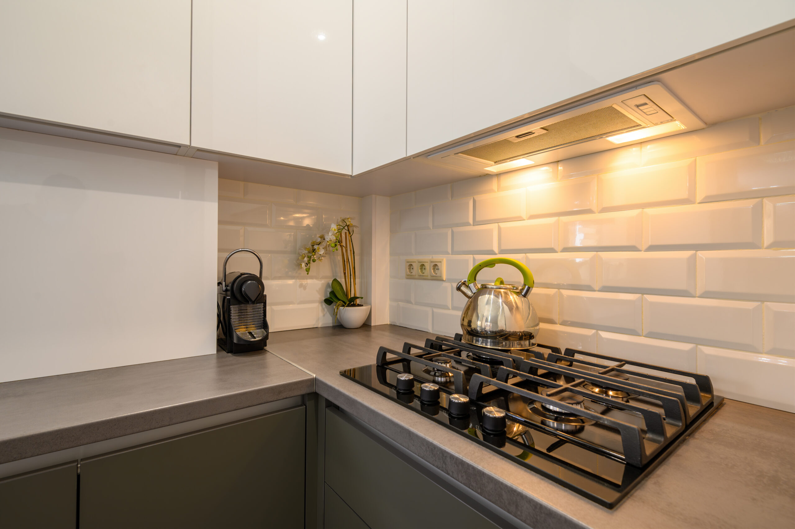 Closeup to well designed small dark grey modern kitchen interior