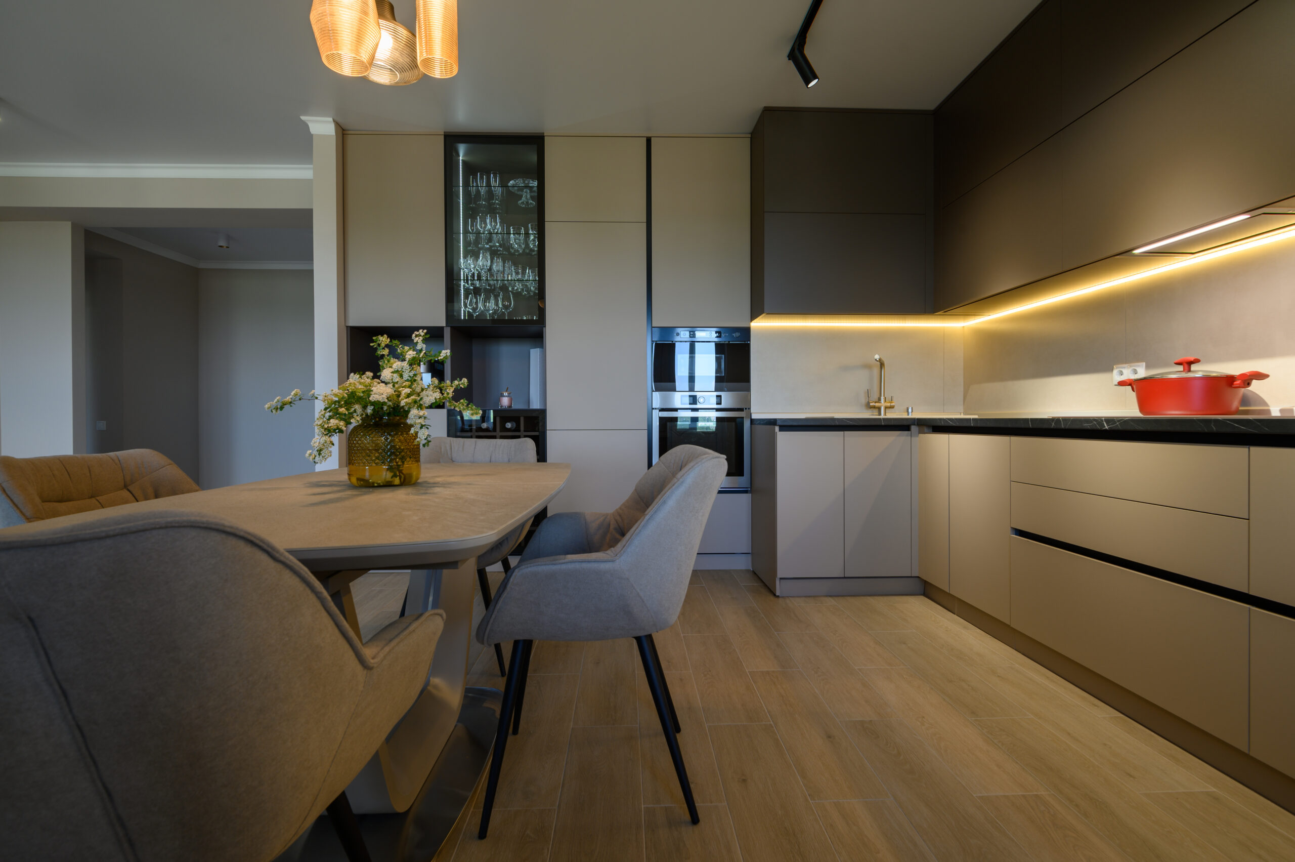 Large modern grey luxurious kitchen and dining room in studio apartment interior