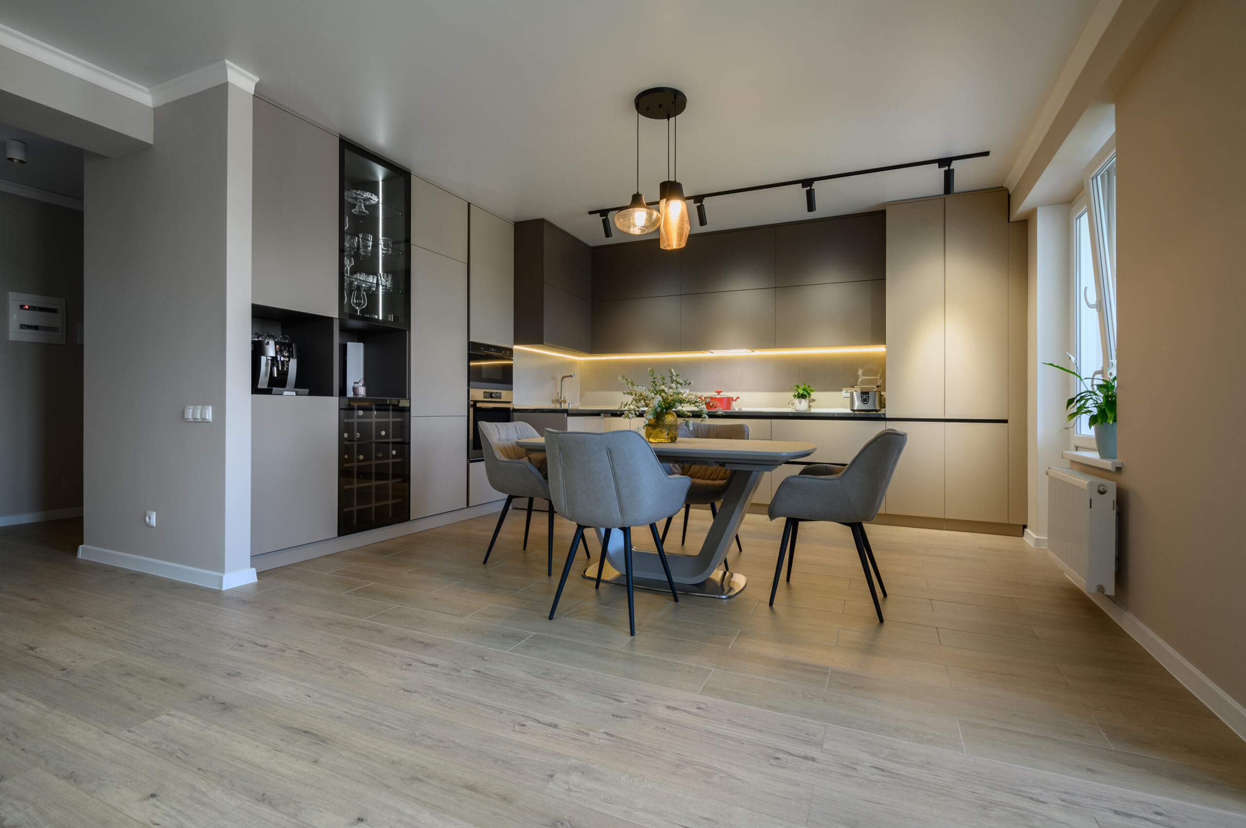 Large modern grey luxurious kitchen and dining room in studio apartment interior