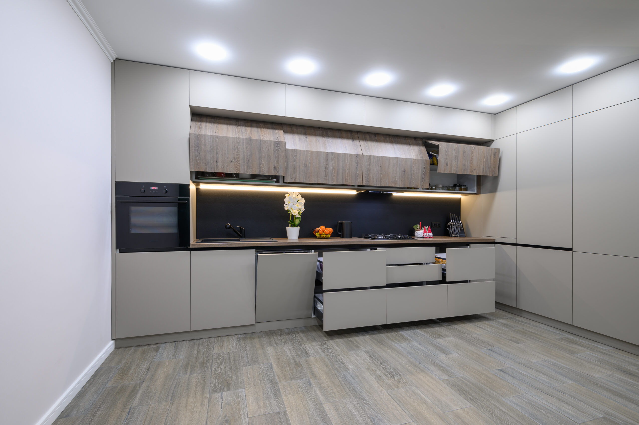 Trendy grey modern kitchen interior showcase, minimalistic furniture with drawers retracred