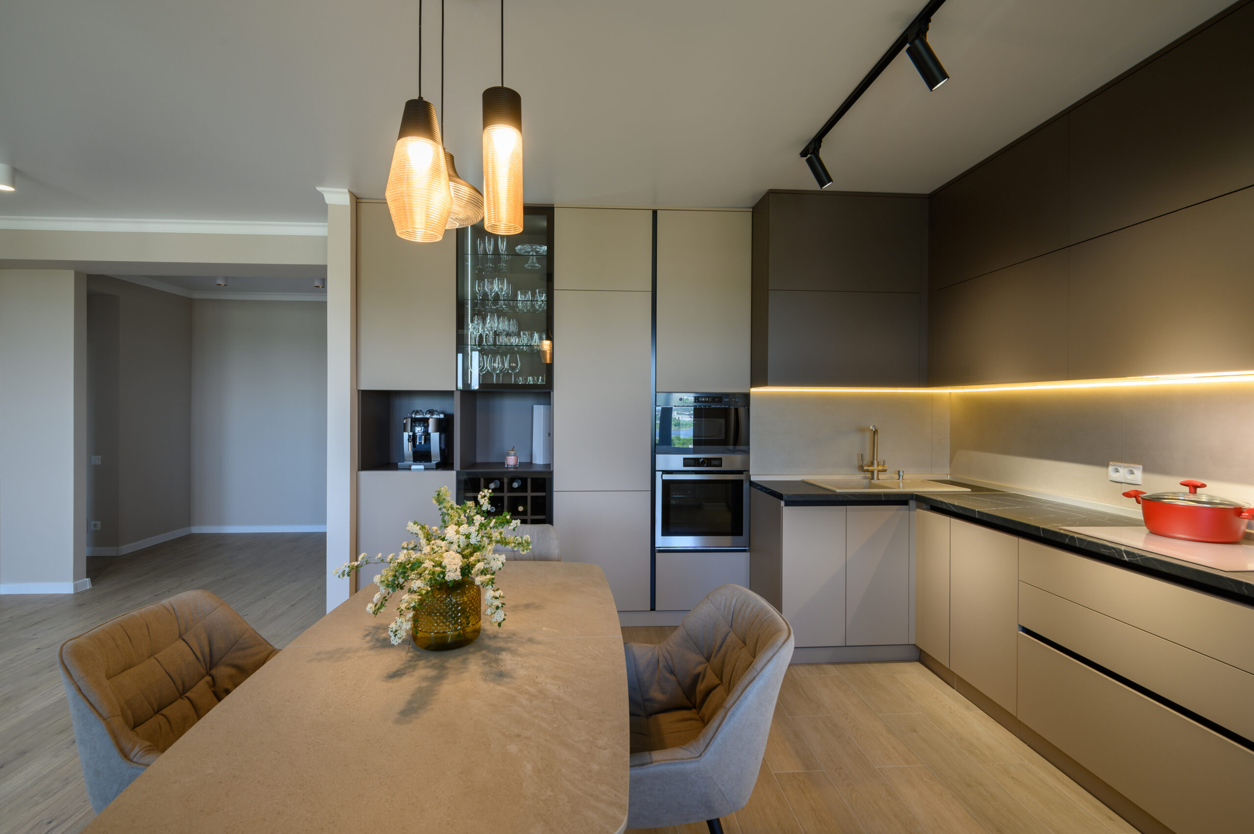 Large modern grey luxurious kitchen and dining room in studio apartment interior