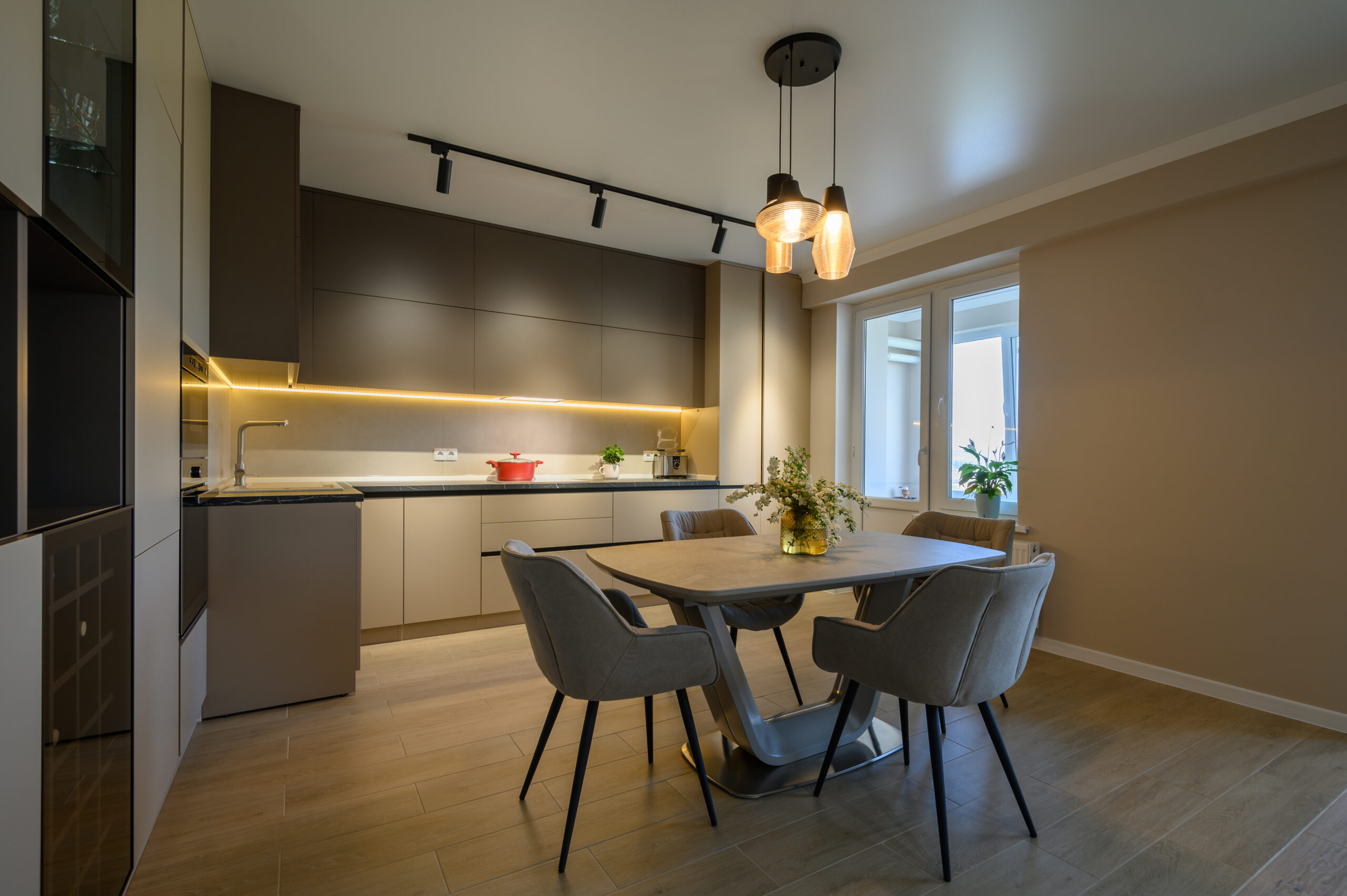 Large modern grey luxurious kitchen and dining room in studio apartment interior